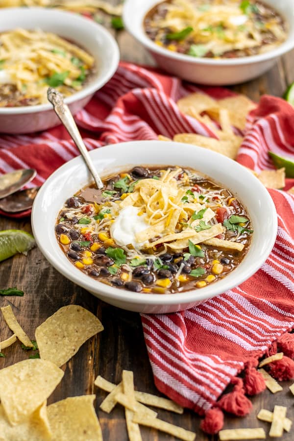 Black Bean Tortilla Soup in a bowl with garnishes